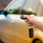 Women's Hand Presses On The Remote Control Car Alarm