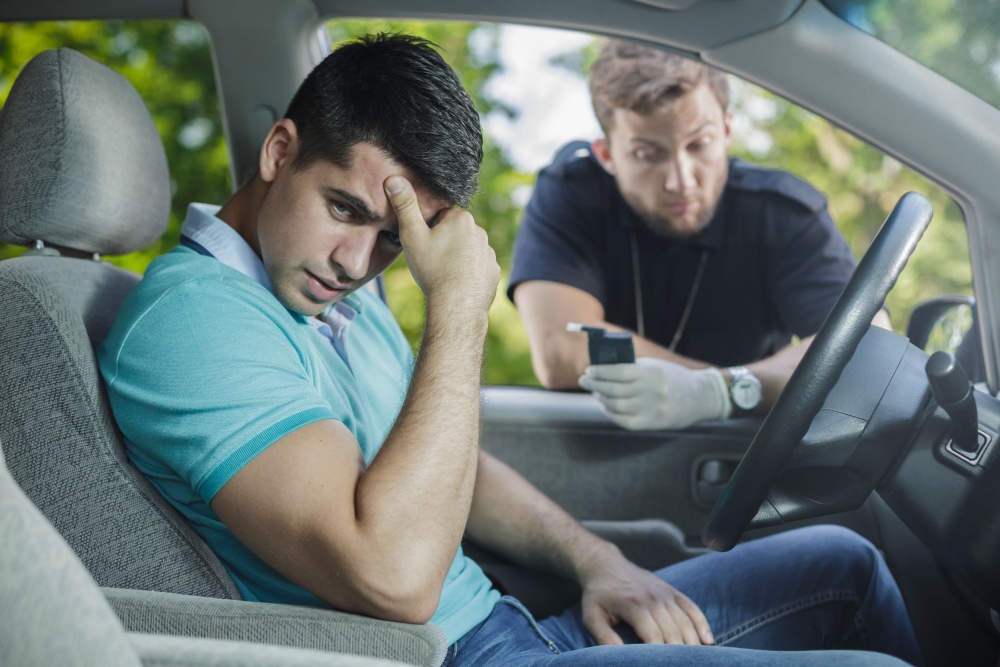 49423463 - worried young driver caught on driving after alcohol